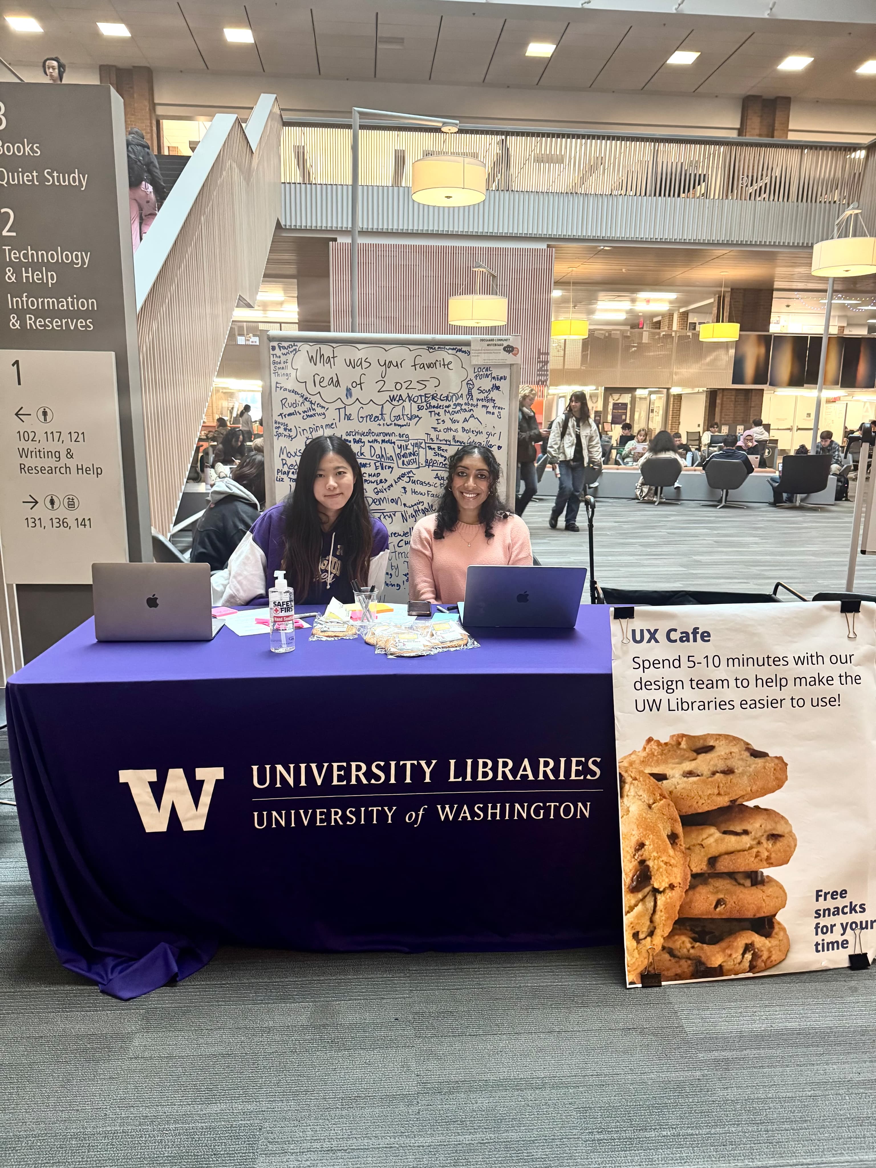 UX Cafe tabling event at Odegaard Library with two team members at the booth
